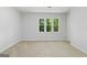 Bright bedroom features a large window allowing natural light, neutral walls, and plush carpeting at 335 Cedar Ln, Fayetteville, GA 30214