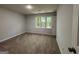 Bedroom featuring carpet, window, and door at 335 Cedar Ln, Fayetteville, GA 30214