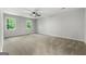 Spacious carpeted bedroom with ceiling fan and two windows offering natural light at 335 Cedar Ln, Fayetteville, GA 30214