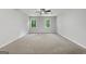 Carpeted bedroom with a ceiling fan and two windows providing natural light at 335 Cedar Ln, Fayetteville, GA 30214