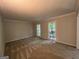 Spacious bedroom featuring neutral carpeting, crown molding, and natural light for a serene ambiance at 335 Cedar Ln, Fayetteville, GA 30214
