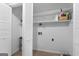 Storage closet with shelving, a white door with slats, and tile flooring at 335 Cedar Ln, Fayetteville, GA 30214
