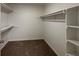 Spacious walk-in closet with shelving and carpeted floor at 335 Cedar Ln, Fayetteville, GA 30214