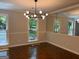 Elegant dining room featuring stylish light fixture, large mirror, and ample natural light at 335 Cedar Ln, Fayetteville, GA 30214