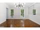 Dining room with parquet floors, modern lighting, and large windows at 335 Cedar Ln, Fayetteville, GA 30214