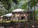 Two-story brick home with mature landscaping, providing a serene and private setting at 335 Cedar Ln, Fayetteville, GA 30214