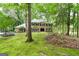 Two-story brick home with black shutters and manicured front lawn, surrounded by lush trees at 335 Cedar Ln, Fayetteville, GA 30214