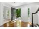 Sunlit foyer with hardwood floors, open doorway, staircase, and side lights at 335 Cedar Ln, Fayetteville, GA 30214