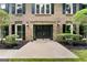 Close-up of double front doors with stone detail and manicured landscaping at 335 Cedar Ln, Fayetteville, GA 30214