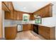 Updated kitchen with stainless appliances, granite countertops, tile backsplash, and ample lighting at 335 Cedar Ln, Fayetteville, GA 30214