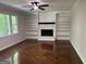 Spacious living room with built-in shelves, fireplace, and hardwood floors, perfect for relaxation at 335 Cedar Ln, Fayetteville, GA 30214