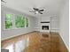 Bright living room boasts a fireplace, built-in shelves, and large windows offering ample natural light at 335 Cedar Ln, Fayetteville, GA 30214