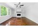 Living room with hardwood floors, fireplace, and bright natural light at 335 Cedar Ln, Fayetteville, GA 30214