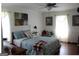 Cozy bedroom features wood floors, natural light, and a comfortable bed at 124 Wynn Rd, Mcdonough, GA 30252