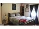 Comfortable bedroom with natural light, bed with blue decorative pillows, and decor at 124 Wynn Rd, Mcdonough, GA 30252