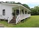 Exterior of the home featuring a long porch with white railings and wooden steps at 124 Wynn Rd, Mcdonough, GA 30252