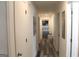 Clean hallway with updated wood flooring and a view into a bedroom at 124 Wynn Rd, Mcdonough, GA 30252