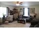Cozy living room featuring neutral colors, updated flooring, and plenty of natural light at 124 Wynn Rd, Mcdonough, GA 30252