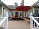 Deck with an outdoor table, chairs, and a red umbrella at 531 Grant Rd, Brooks, GA 30205