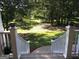 Scenic view from the porch steps overlooking a lush, green backyard and trees at 531 Grant Rd, Brooks, GA 30205