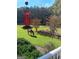 Well-maintained backyard featuring a horse grazing on lush green grass and trees, creating a peaceful rural setting at 531 Grant Rd, Brooks, GA 30205
