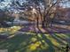 Expansive backyard featuring mature trees and a tranquil pond, perfect for relaxation and outdoor enjoyment at 531 Grant Rd, Brooks, GA 30205