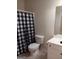 Bathroom featuring a vanity, toilet, and checkered shower curtain at 531 Grant Rd, Brooks, GA 30205