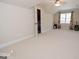 Spacious bedroom offers a ceiling fan, dormer windows, and neutral carpet at 531 Grant Rd, Brooks, GA 30205