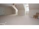 Large bonus bedroom featuring neutral carpet, a ceiling fan and chair by the window at 531 Grant Rd, Brooks, GA 30205