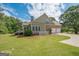A well-maintained home with a lush green lawn, a spacious backyard, and a two-car garage at 531 Grant Rd, Brooks, GA 30205