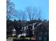 Exterior view of a house showcasing its covered porch, dormers, and mature trees at 531 Grant Rd, Brooks, GA 30205