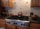 Spacious kitchen featuring stainless steel stove, granite countertops, and decorative backsplash at 531 Grant Rd, Brooks, GA 30205