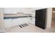 Bright kitchen featuring white cabinets, laminate counters, and a black refrigerator at 531 Grant Rd, Brooks, GA 30205