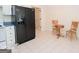 Cozy kitchen area featuring a black refrigerator, a small table, and tile flooring at 531 Grant Rd, Brooks, GA 30205