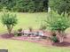 Charming outdoor seating area surrounded by lush landscaping and flowering plants at 531 Grant Rd, Brooks, GA 30205