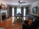 Open living room features a fireplace, hardwood floors and large windows at 531 Grant Rd, Brooks, GA 30205