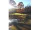 Scenic view of a serene pond reflecting sunlight, enhancing the natural beauty of the property at 531 Grant Rd, Brooks, GA 30205