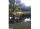 Picturesque pond with home reflecting in the calm water surrounded by mature trees at 531 Grant Rd, Brooks, GA 30205