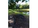 Picturesque view of a tranquil pond with a bench, surrounded by lush greenery and mature trees at 531 Grant Rd, Brooks, GA 30205