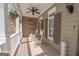 Charming front porch with rocking chairs, stone accents, and a decorative birdhouse at 531 Grant Rd, Brooks, GA 30205