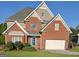 Charming two-story brick home with a manicured front yard and a two-car garage, creating an inviting curb appeal at 3932 Misty Lake, Ellenwood, GA 30294