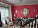 An elegant living room with hardwood floors, plush seating and a decorative mirror creates a cozy and stylish space at 3932 Misty Lake, Ellenwood, GA 30294