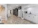 Basement with staircase, tile flooring, kitchenette area with white cabinets and appliances at 2545 Rockbridge Nw Rd, Conyers, GA 30012