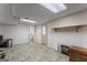 Unfinished basement area with tiled floors, open floorplan, and a door to the exterior at 2545 Rockbridge Nw Rd, Conyers, GA 30012
