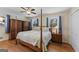 Bedroom featuring wood floors, natural light, blue curtains, and an ornate bed frame at 2545 Rockbridge Nw Rd, Conyers, GA 30012