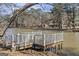 View of a small wooden dock with white railings on a lake surrounded by trees at 2545 Rockbridge Nw Rd, Conyers, GA 30012