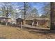 Classic brick home with a inviting front porch and a view of the landscaped yard at 2545 Rockbridge Nw Rd, Conyers, GA 30012