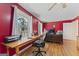 Bright home office featuring wood floors, wooden desk, and natural light from the windows at 2545 Rockbridge Nw Rd, Conyers, GA 30012