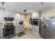 Modern kitchen featuring sleek gray cabinets, stainless steel appliances, and stylish tile backsplash at 2545 Rockbridge Nw Rd, Conyers, GA 30012