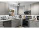 Updated kitchen boasting gray cabinetry, stainless steel appliances, and a bright, clean aesthetic at 2545 Rockbridge Nw Rd, Conyers, GA 30012